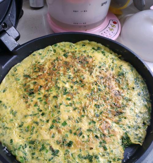 松软鸡蛋饼的制作方法（轻松做出口感Q软的美味鸡蛋饼）